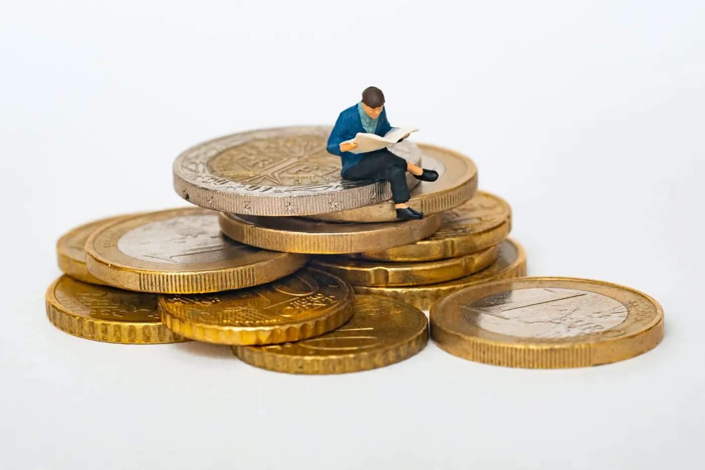 A figurine sitting on a stack of coins